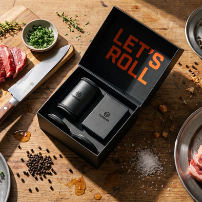 Steak preparation scene with a 'Let's Roll' box on a wooden surface.