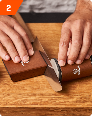 Roll tumbler sharpener along the blade